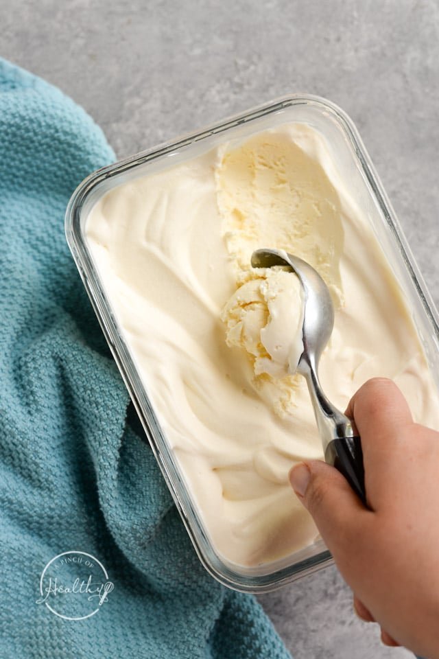 Tools and equipment used for making homemade ice cream on a marble counter.