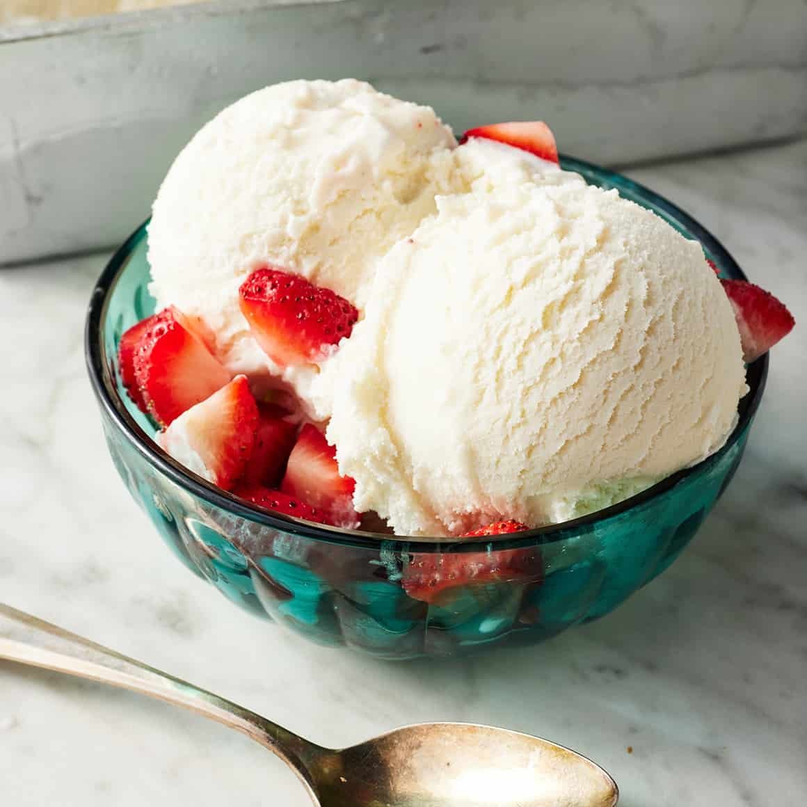 Assorted fresh toppings for homemade ice cream displayed in small glass bowls.