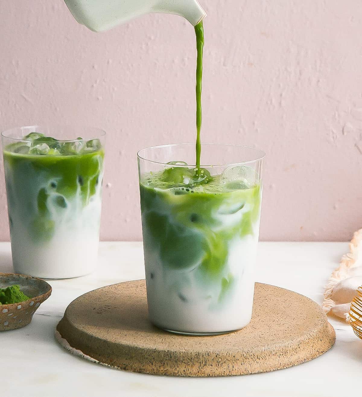 Two glasses showing properly mixed and poorly mixed iced matcha for comparison.