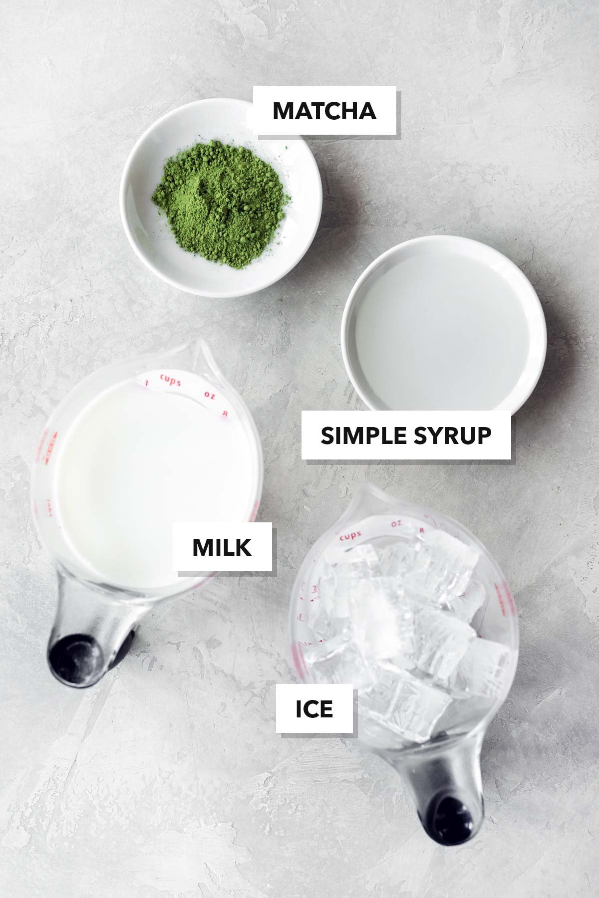 An organized collection of tools and ingredients for making the perfect iced matcha.