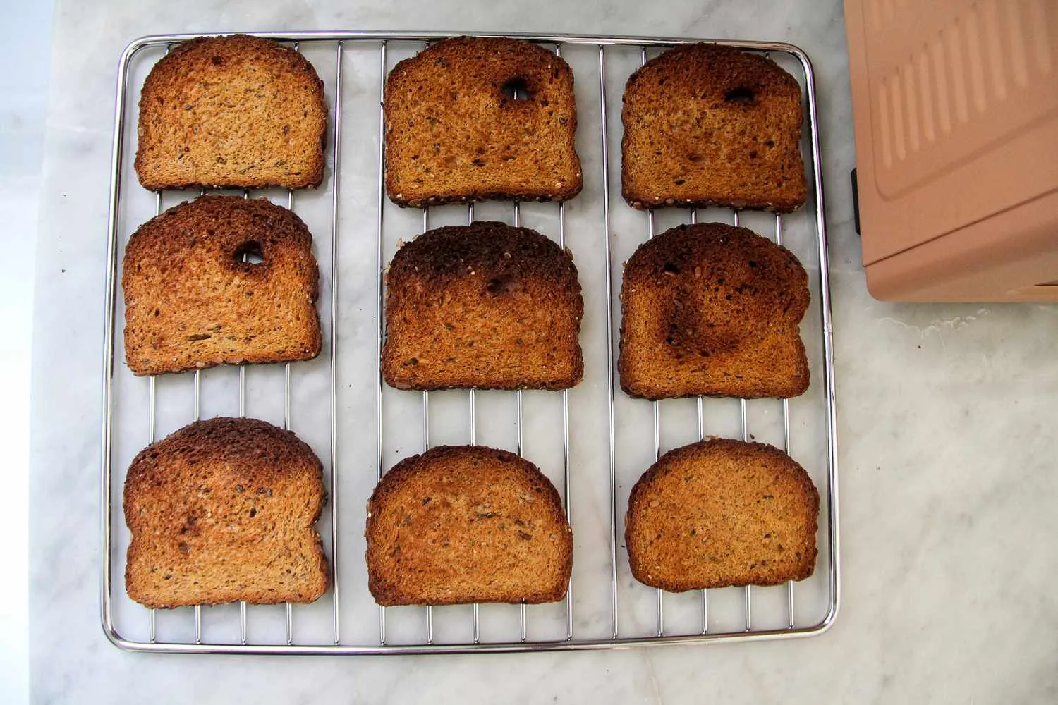 Three people in a kitchen with a Wonder Oven, toast, and a tablet